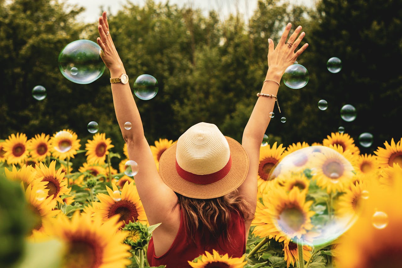 Woman experiencing Ultimate Freedom in a sunflower garden